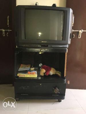 Sharp TV with TV stand.