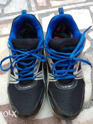 Pair Of Black And Blue Running Shoes