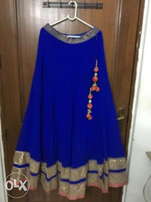 This blue lehenga has a pink detailing is