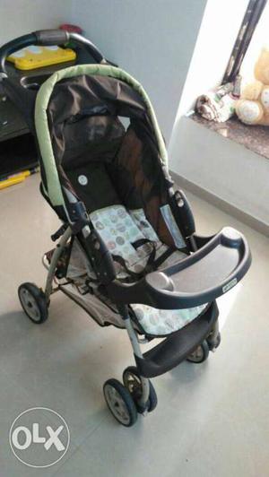 Baby's Green And Black Stroller
