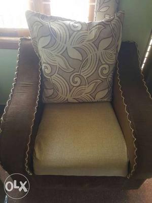 Brown And Beige Armchair And Throw Pillow