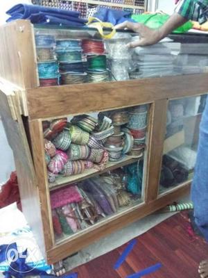 Brown Wooden Sliding Door Cabinet And Yarn With Ribbons And