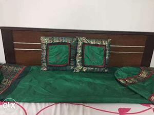 Diwaan spread with 3 cushions and 2 round pillows