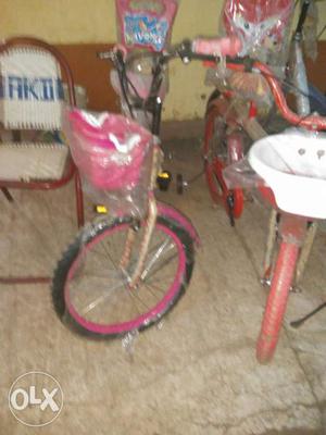 2 Toddler's Pink And Red Bicycles