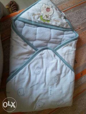 Quilted baby wrap around. Keeps the baby warm and easy to