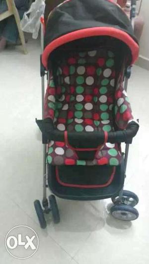 Baby's Black Red And Green Polka Dotted Stroller