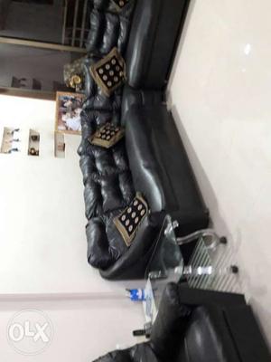 Black Leather Sectional Sofa With Floral Throw Pillows