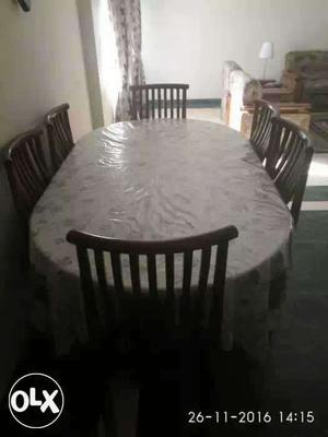 Dining table with six chairs made of pure teak.