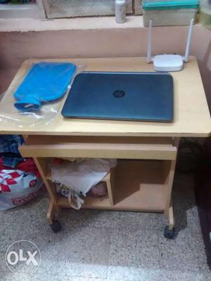 Grey Hp Laptop And Brown Wooden Wheeled Computer Desk And