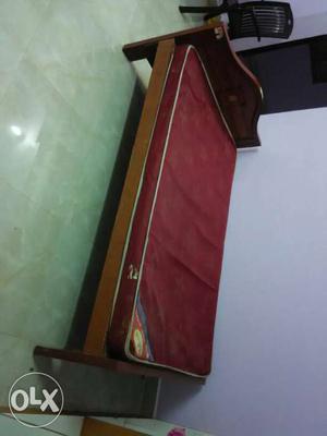 Maroon Mattress And Brown Wooden Bed Frame