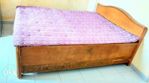 Purple Mattress And Brown Wooden Bed