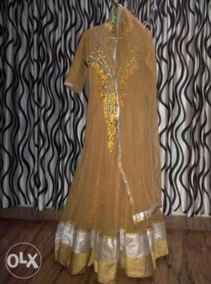 Bridal anarkali in golden color with embroidery