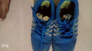 Pair Of Blue And Green Nike Running Shoes