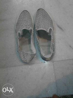 Pair Of Gray And White Slip On Shoes