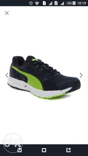 Unpair Of Black White And Green Puma Sneakers