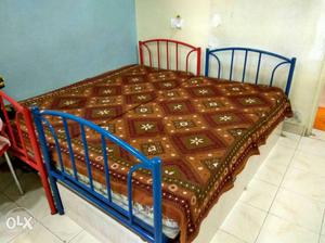 2 Metal Twin Sized Bed And Brown Floral Bed Spreader with
