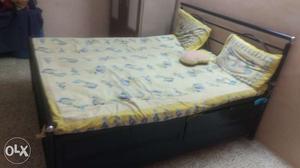 Metal Bed with Boxes and Boxes inside of bed also.