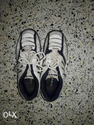 Pair Of White And Black Walking Shoes