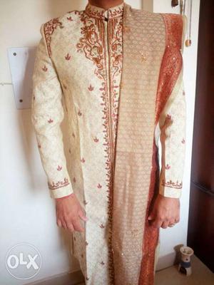 Beige and red Sherwani with beautifully designed by designer