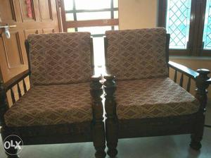 2 Brown Wooden Framed Padded Armchairs