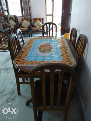 Teakwood dinning table with six chairs in