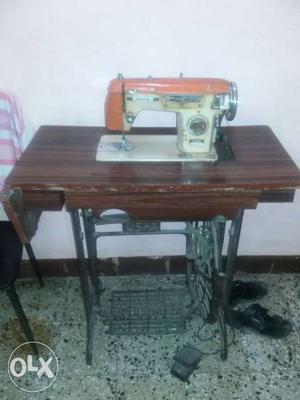 White And Orange Sewing Machine