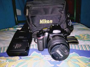 Black Nikon Dslr Camera And Bag
