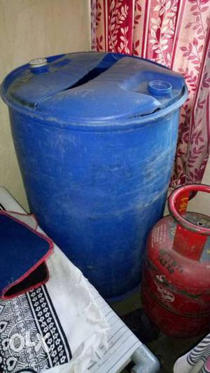 Blue Plastic Drum And Red Propane Tank