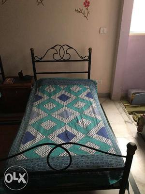A wrought iron single bed (6feet by 3 feet) with
