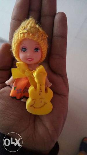 Girl Mini Doll In Yellow And Orange Shirt And Knit Cap