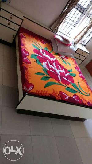 Orange Red And Green Floral Bed Sheet With White Wooden