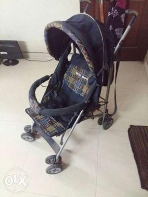 Purple-and-grey Stroller Foldable. Easy to move and store..