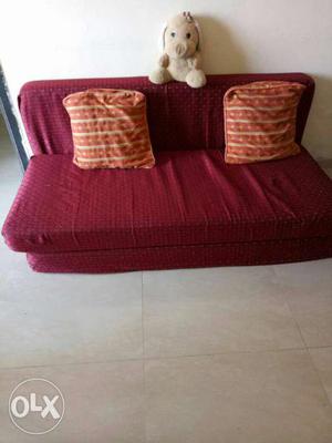 Red Sofa And 2orange Throw Pillows