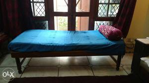 Single wooden frame bed with mattress