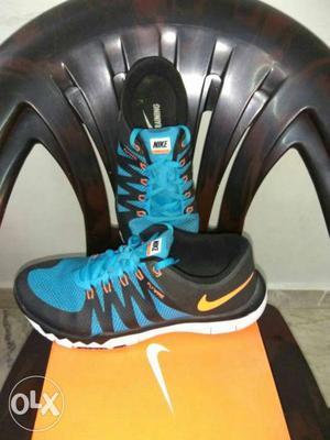Pair Of Blue And Black Nike Low Top Sneakers