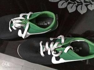 Pair Of Green White And Black Low Tops Sneakers