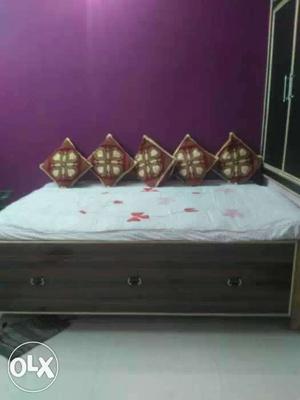 Brown Wooden Bed With Mattress And Florals