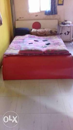 Red And White Panel Bed Frame With Pink Bed Sheet