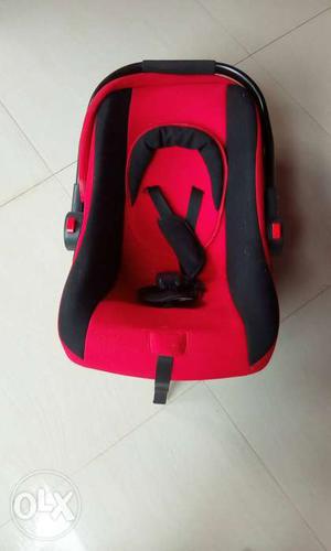 Baby's Red And Black Car Seat