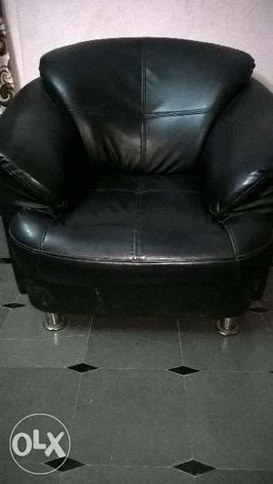 2 black colour single leather sofas