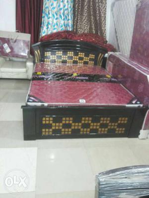 Black And Gold Wooden Bed Framed And Red Mattress