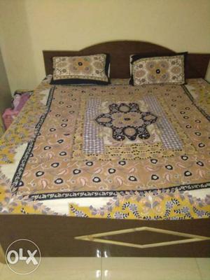 Brown, Yellow And White Floral Bedspread With Bed