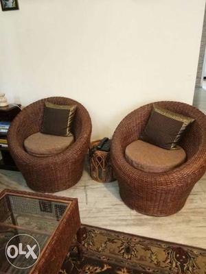 Cane sofa with cushions and center table.