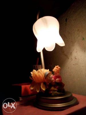 Table lamp with two doll hanged with it