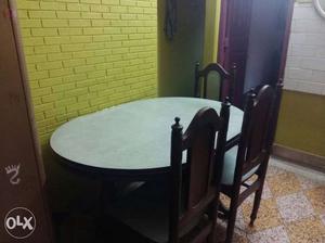 Wooden table with 3 chairs in good condition.