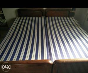 2 Teak Wooden cots With Blue And White Mattress