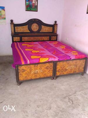 Brown Wooden Bed With Purple And Yellow Mattress