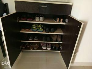 Foot Wears In Brown Wooden Cabinet