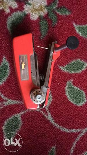 Red And Gray Handheld Sewing Machine