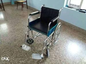 Unused Black And Silver Leather Wheel Chair